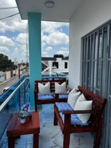 two benches on a balcony with pillows on them at Apartamentos SCARLEM in Higuey