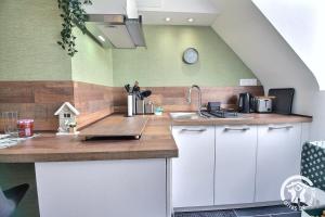 a kitchen with a sink and a counter top at La maison verte in Ploeuc