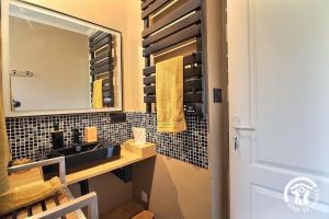 a bathroom with a sink and a mirror at La maison verte in Ploeuc +21 photos