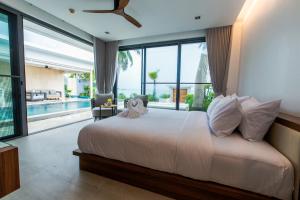 a bedroom with a large bed and a large window at Masima Samui Villa in Koh Samui +232 photos