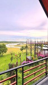 a view from the balcony of a roller coaster at ปลายเขื่อนแคมป์ปิ้ง บ้านแฟมรี่ in Sirindhorn +5 photos