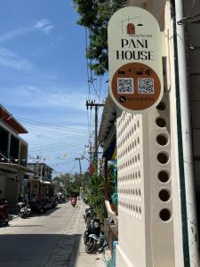 a sign for a plant house on the side of a building at Pani house in Ko Samed