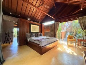 a bedroom with a large bed in a room at Maso Christian Villa Canggu in Tumbak Bayuh +32 photos