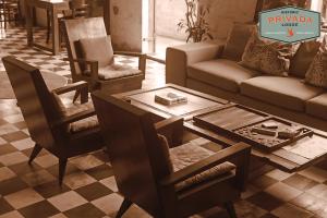 a living room with a couch and a table and chairs at Privada Lodge - Historic Hotel in Kratie