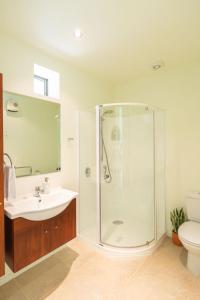 a bathroom with a shower and a sink and a toilet at Elevated Views Little Kaiteriteri in Kaiteriteri +46 photos