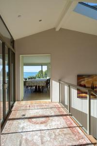 a dining room with a table and a view of the ocean at Elevated Views Little Kaiteriteri in Kaiteriteri