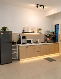 a kitchen with a refrigerator and a microwave at Atlantis Residences by UVM Stay -4 Pax in Malacca