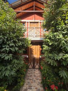 a house with a walkway in front of a building at Mi Ranchito Capurganá in Capurganá