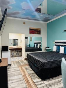 a bedroom with two beds and blue walls at Dream Inn in Inglewood