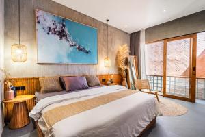 a bedroom with a large bed and a large window at Villa Dinova in Uluwatu +22 photos