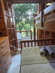 a bedroom with a bunk bed and a large window at Chalé Veraneio-Itú-SP Vista para o lago Camping Carrion in Itu