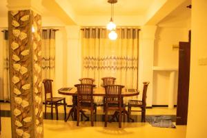 a dining room with a table and chairs at Villa Deniyaya in Deniyaya
