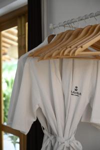 a bunch of white shirts hanging on a rack at Mayava Villa in Ahangama