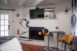 a living room with a fireplace with two chairs and a table at National Harbor Suite 1 in Fort Washington