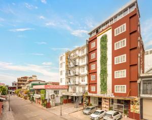 an apartment building with plants on the side of it at Vina Boutique Hotel in Hue