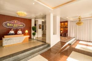 a lobby of a hotel with a reception desk at Vina Boutique Hotel in Hue