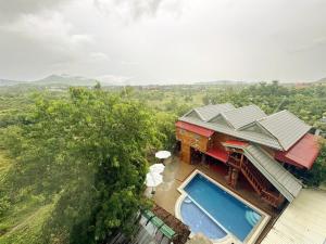 an aerial view of a house with a swimming pool at Cloudy Hill Homestay and Hostel in Kampot