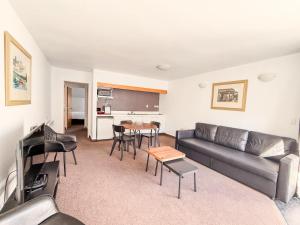 a living room with a couch and a table at Amity Serviced Apartments in Queenstown