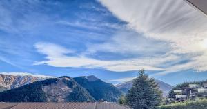 a view of a mountain range with a tree at Amity Serviced Apartments in Queenstown +13 photos