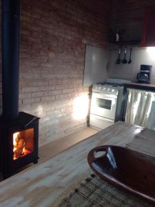 a kitchen with a woodburning stove in a kitchen at Refugio de Monte in San Luis