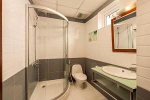 a bathroom with a shower and a toilet and a sink at Vina Boutique Hotel in Hue +52 photos