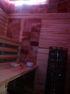 a sauna with a table and a bowl on it at Apartmány Kuřátko in Benecko
