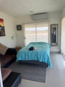 a person laying on a bed in a bedroom at DEPARTAMENTO SOL Y MAR in San Carlos