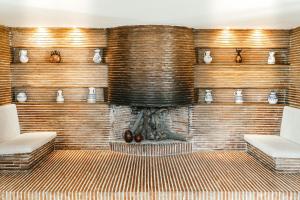 a living room with a brick wall with a fireplace at Parador de Manzanares in Manzanares