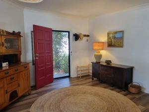 a living room with a red door and a table at Salty Dog in Long Beach
