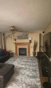 a living room with a couch and a fireplace at The Universal Home Stay in Akron