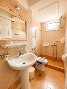 a bathroom with a sink and a toilet at STUDIOS ATHENA in Megalochori