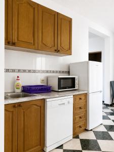 a kitchen with a white refrigerator and a microwave at Apartments Buena Vista in Ulcinj +5 photos
