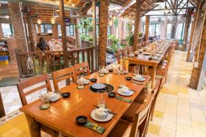 a row of wooden tables in a restaurant at Cozy Skyline Escape 2Bedroom Near Hanoi Major Business District in Hanoi