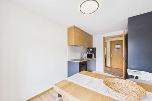 a small room with a bed and a kitchen at Alpine Apartment near Saas-Fee for 4 in Saas-Almagell