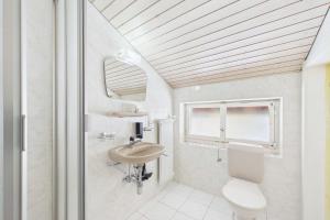 a bathroom with a sink and a toilet and a mirror at Alpine Apartment near Saas-Fee for 4 in Saas-Almagell +3 photos