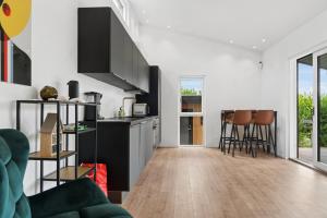 a living room with a kitchen and a table at Newly Renovated Cottage With Sauna in Melby