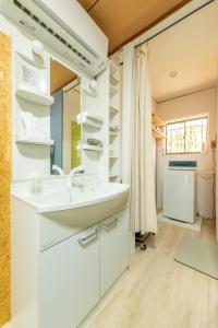 a bathroom with a sink and a mirror at Guesthouse Ichiedo in Kashihara +71 photos