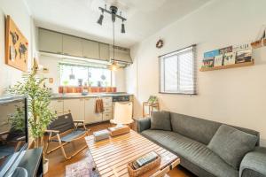 a living room with a couch and a table at Guesthouse Ichiedo in Kashihara