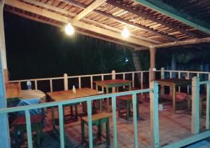 a patio with tables and chairs on a deck at Seasons Four Jungle Cabana - Breakfast - Beach 10Mtr- Wildlife in Matara +56 photos