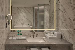 a bathroom with a sink and a mirror at JW Marriott Hotel Kuwait in Kuwait +63 photos