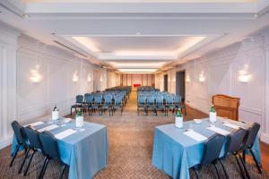 a room with rows of tables and chairs in it at Rome Marriott Grand Hotel Flora in Rome