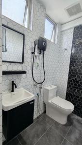 a bathroom with a toilet and a sink at Dwan Hotel in Kota Bharu +18 photos
