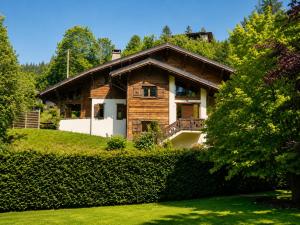 a house on a hill with trees and grass at Chalet Adonis - Montriond, Morzine, Avoriaz in Montriond