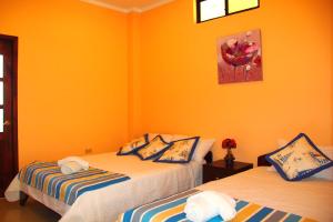 Postel nebo postele na pokoji v ubytování Hostal Duncan