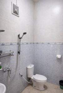 a bathroom with a toilet and a shower at Parama Bromo Hotel in Ngadisari