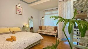a bedroom with a bed and a plant in it at Vanilla Homestay Da Lat in Da Lat