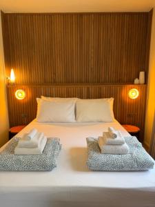 a bedroom with a bed with two towels on it at The Lewis House in San Juan