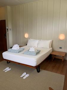 a bed with two slippers on it in a room at The Lewis House in San Juan +1 photo