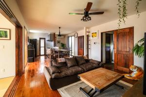 a living room with a couch and a coffee table at The Villa Miyako in Hirara