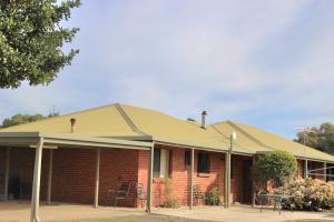 a red brick house with a pitched roof at Willunga Farm Retreat in Willunga